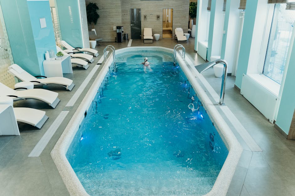 Bright indoor spa pool with lounge chairs and calm atmosphere, ideal for relaxation